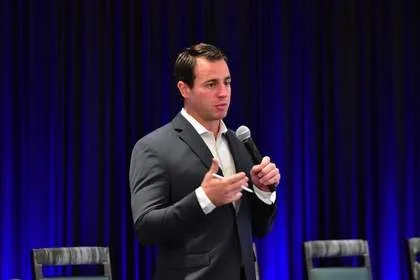 Speaker presenting on stage at Tech Valley Cybersecurity Symposium
